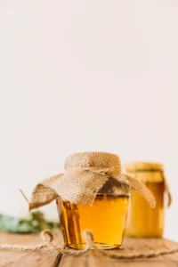 fresh-honey-closed-jar-wooden-surface